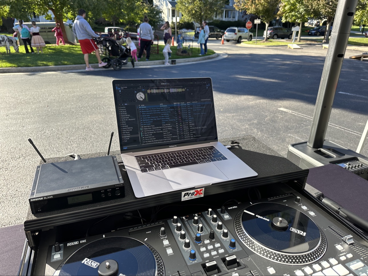 DJ Solo performing outdoors at a neighborhood event