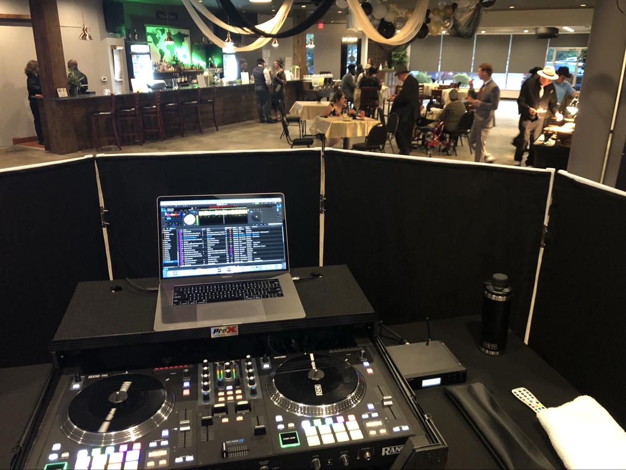 DJ setup in an upscale lounge venue with a bar